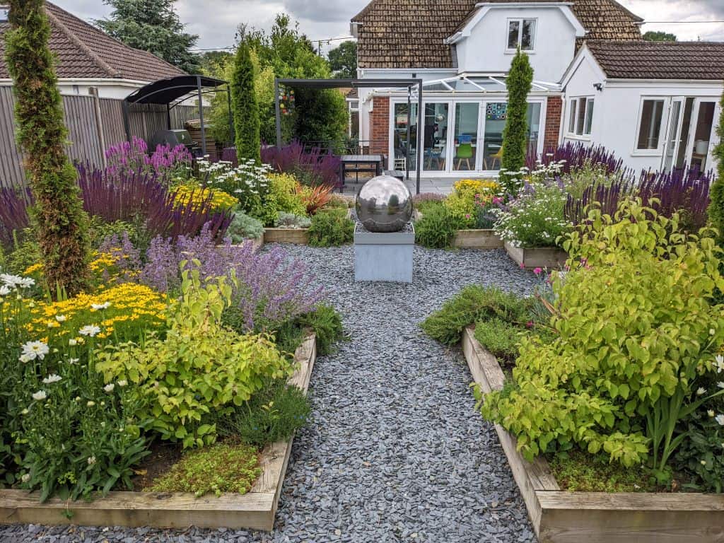 Mediterranean garden planting with formal raised beds by Richard Walters Mediterranean-style garden featuring formal raised beds and planting, designed by Richard Walters.
