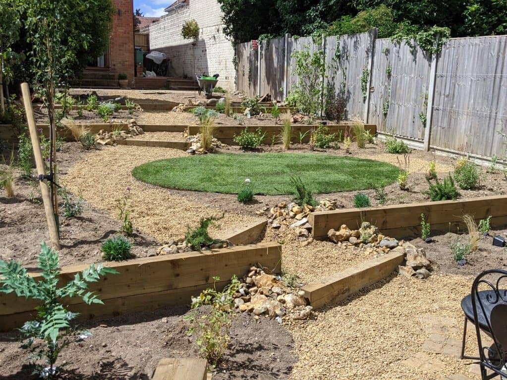 Terraced garden in Norwich Terraced garden after completion showing oval lawn and mediterranean plants